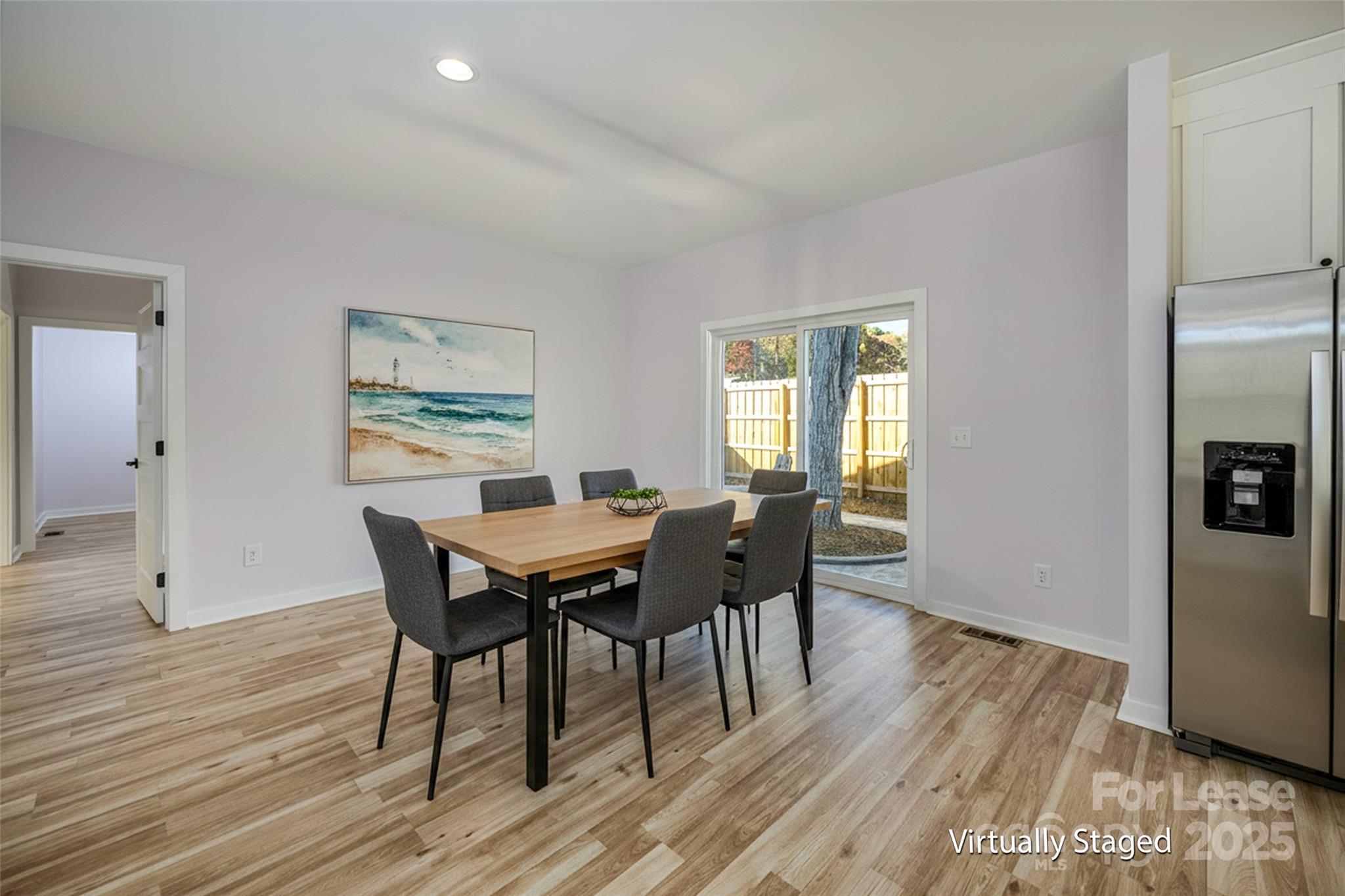 7039 Executive Circle Denver, NC 28037 - Photo 9 of 48 a view of a dining room with furniture and wooden floor