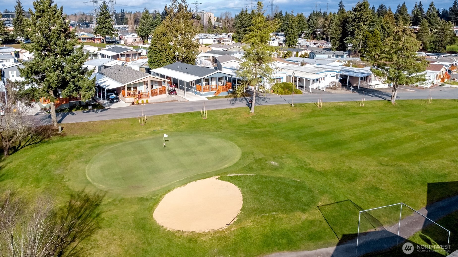 an aerial view of residential houses with outdoor space and swimming pool