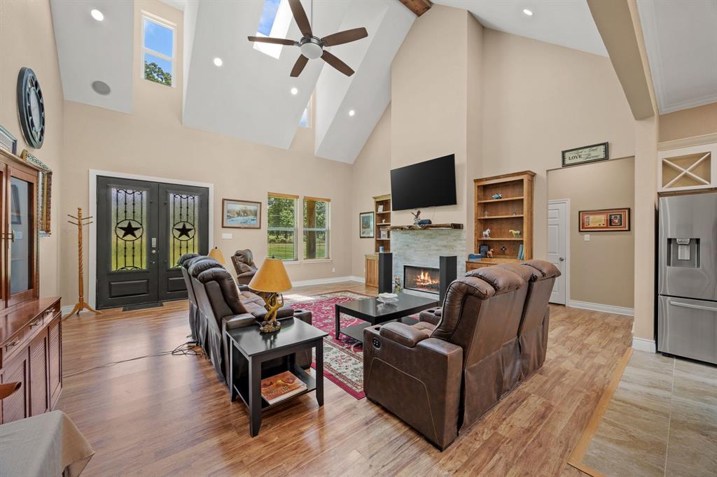 5230 Esquire Estates Road Mabank, TX 75156 - Photo 3 of 19 a living room with furniture a flat screen tv and a fireplace