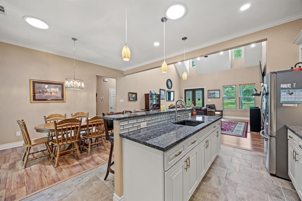 5230 Esquire Estates Road Mabank, TX 75156 - Photo 5 of 19 a kitchen with stainless steel appliances granite countertop a stove and a wooden cabinets