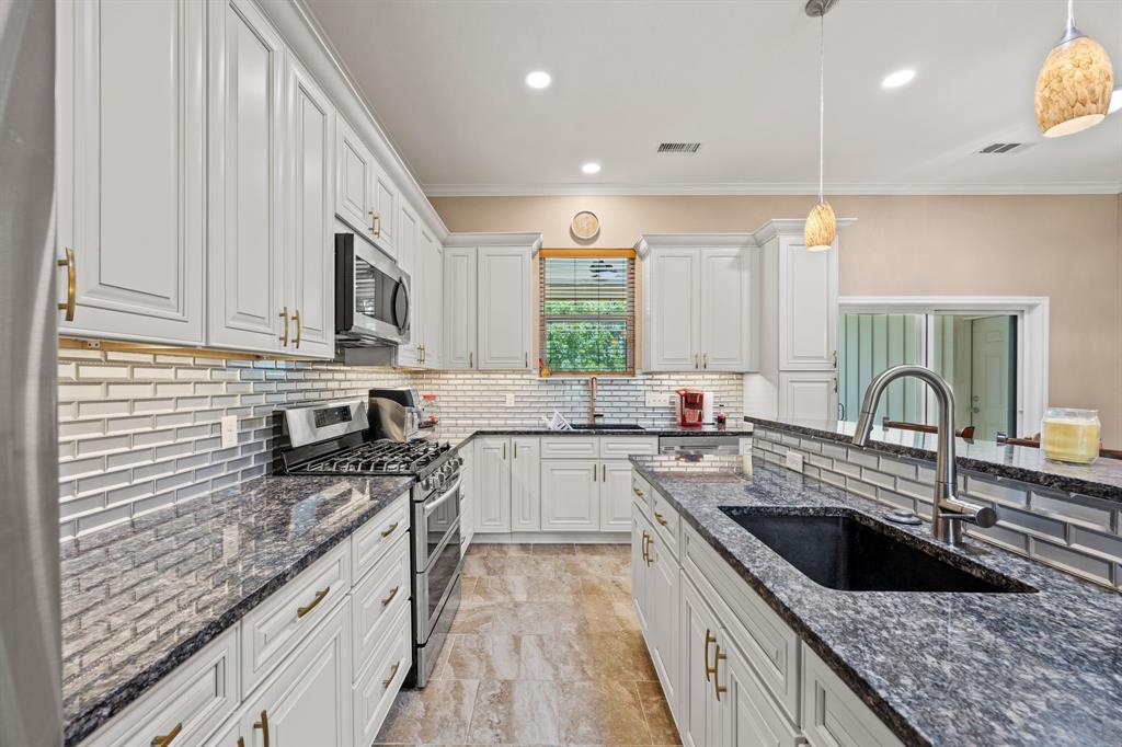 5230 Esquire Estates Road Mabank, TX 75156 - Photo 6 of 19 a kitchen with stainless steel appliances granite countertop a sink a stove top oven a counter space and cabinets