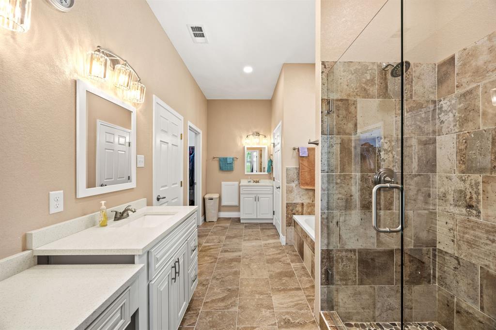 5230 Esquire Estates Road Mabank, TX 75156 - Photo 9 of 19 a spacious bathroom with a double vanity sink a mirror and a shower