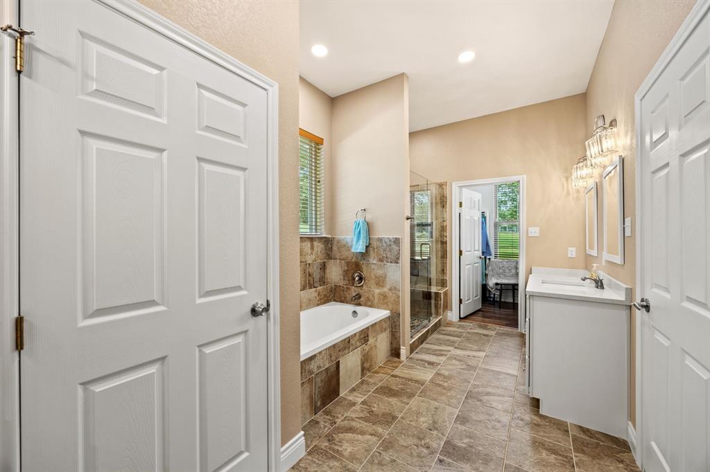 5230 Esquire Estates Road Mabank, TX 75156 - Photo 10 of 19 a bathroom with a tub shower and sink