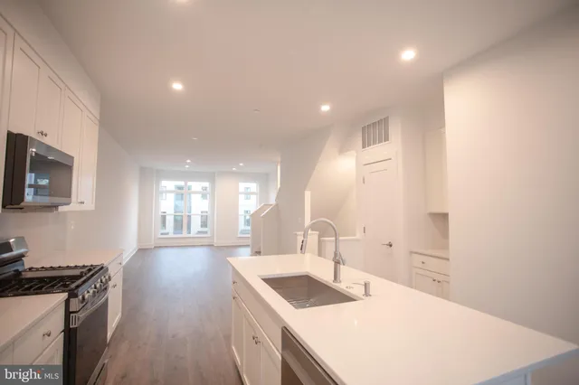 a kitchen with a sink stove and cabinets