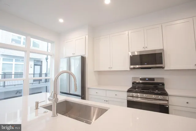 a kitchen with granite countertop a stove and a sink
