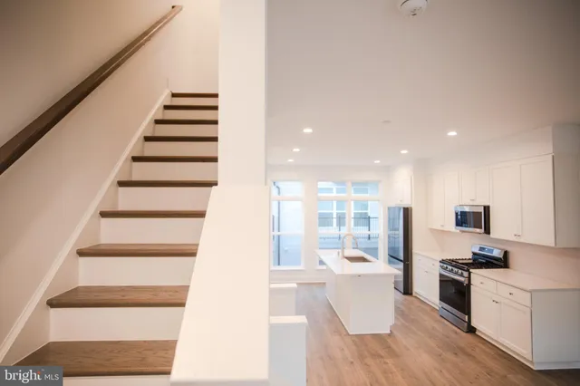 a view of kitchen with stainless steel appliances cabinets and a counter top space