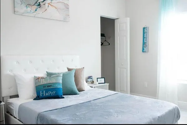 a bedroom with a bed and a window