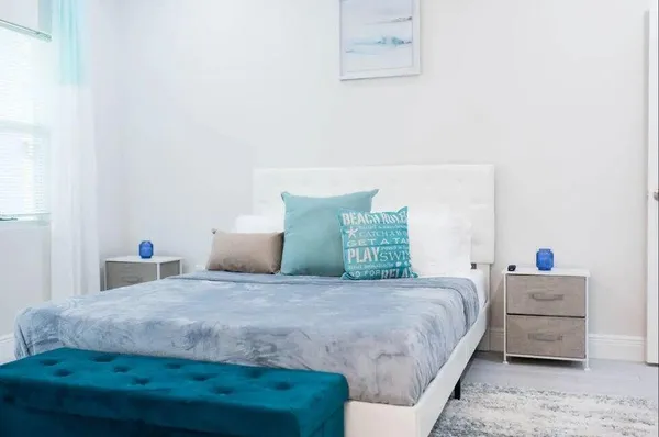 a bedroom with a bed and two wall painting