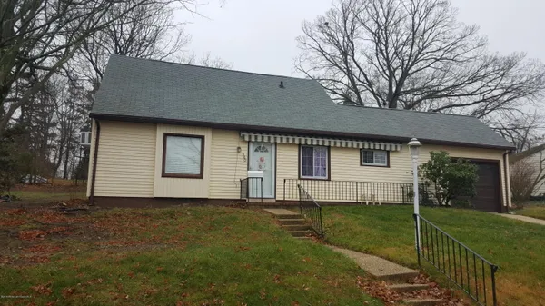 a front view of house with yard and green space