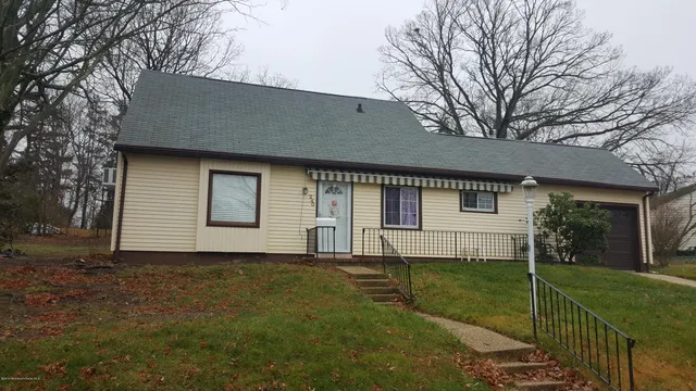 a front view of house with yard and green space
