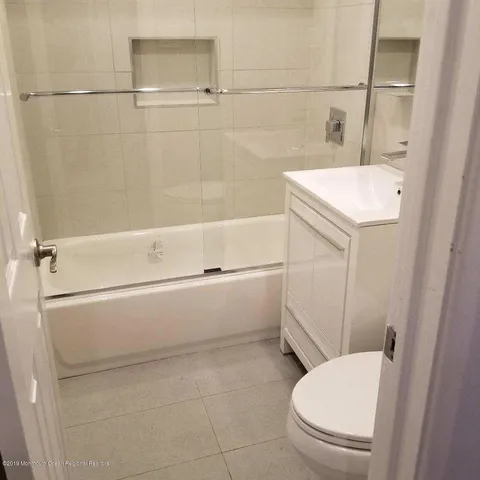 a bathroom with a sink a toilet and bathtub