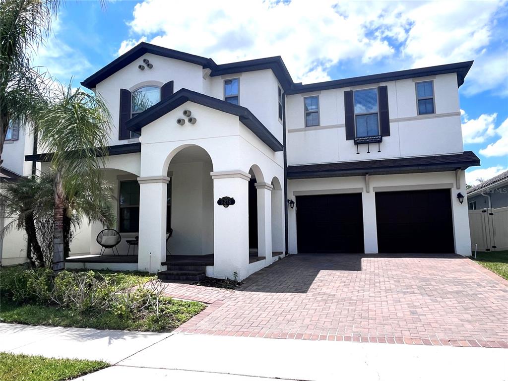 8278 Procida Isle Lane Windermere, FL 34786 - Photo 1 of 90 a front view of a house with a garden