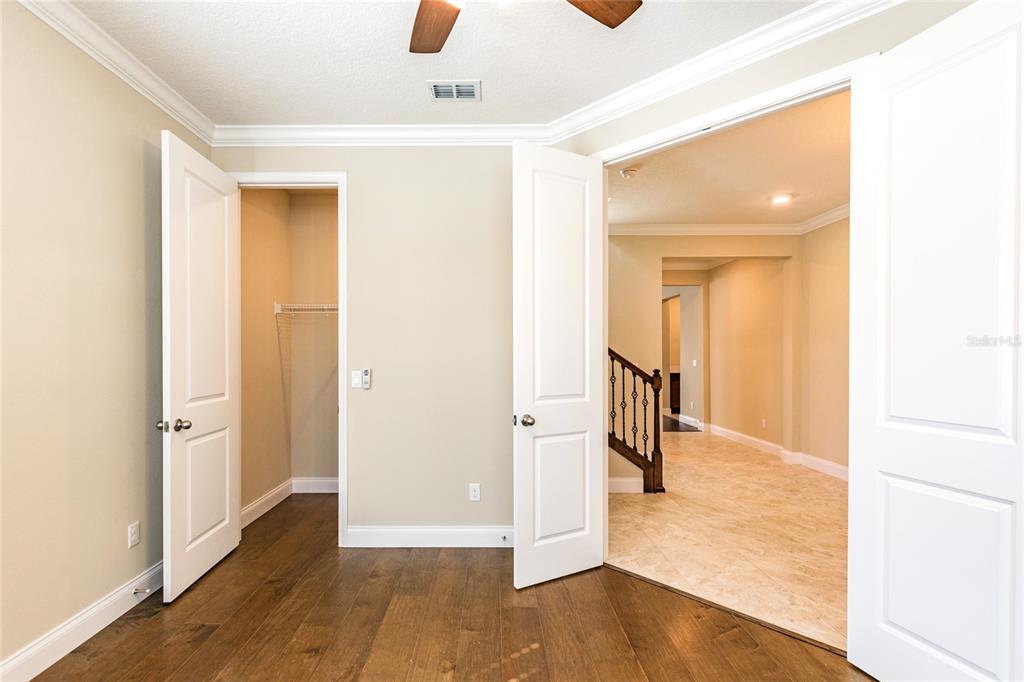 8278 Procida Isle Lane Windermere, FL 34786 - Photo 11 of 90 a view of a hallway with wooden floor and entryway