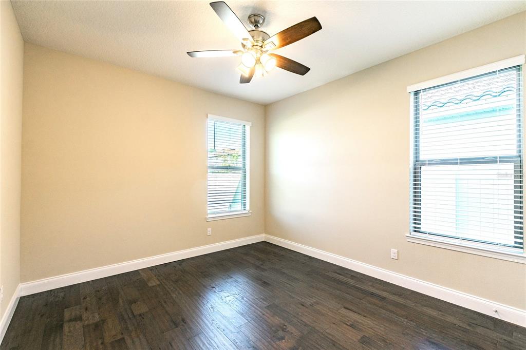 8278 Procida Isle Lane Windermere, FL 34786 - Photo 16 of 90 an empty room with wooden floor and windows