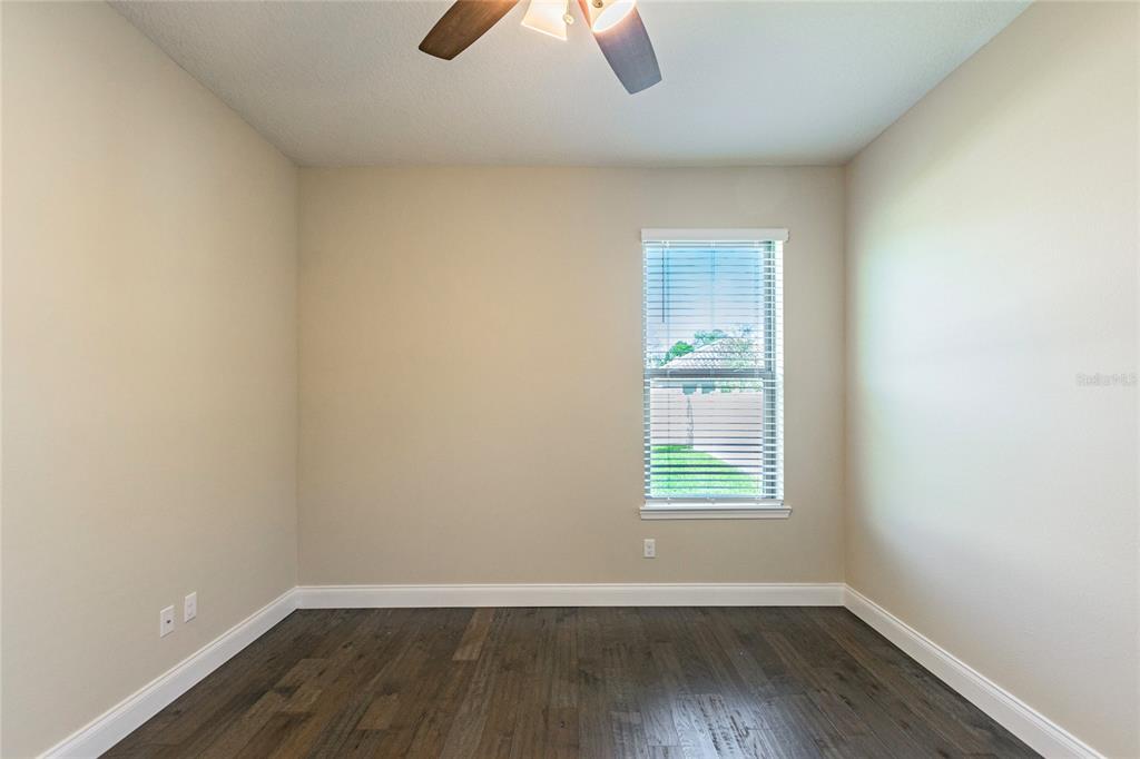 8278 Procida Isle Lane Windermere, FL 34786 - Photo 17 of 90 a view of an empty room with wooden floor and window