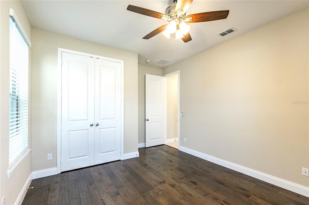 8278 Procida Isle Lane Windermere, FL 34786 - Photo 19 of 90 an empty room with wooden floor closet and fan