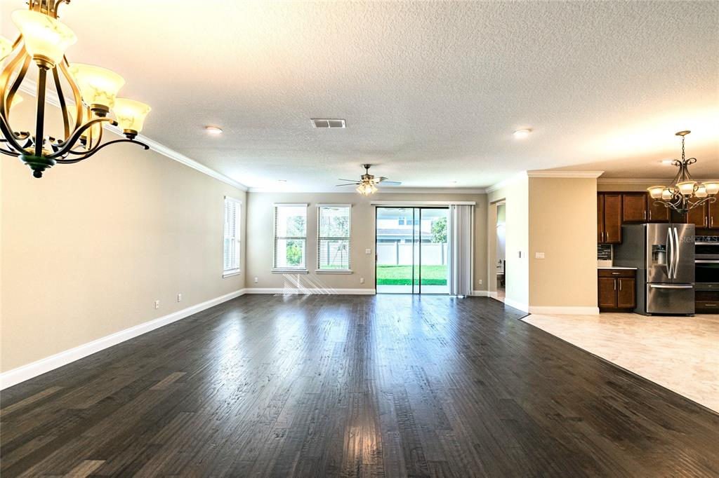 8278 Procida Isle Lane Windermere, FL 34786 - Photo 20 of 90 a view of an empty room with wooden floor and a window