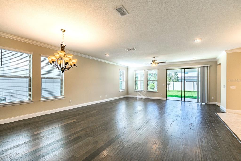 8278 Procida Isle Lane Windermere, FL 34786 - Photo 22 of 90 a view of an empty room with wooden floor and a window