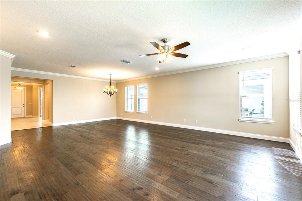 8278 Procida Isle Lane Windermere, FL 34786 - Photo 33 of 90 a view of an empty room with a window and wooden floor