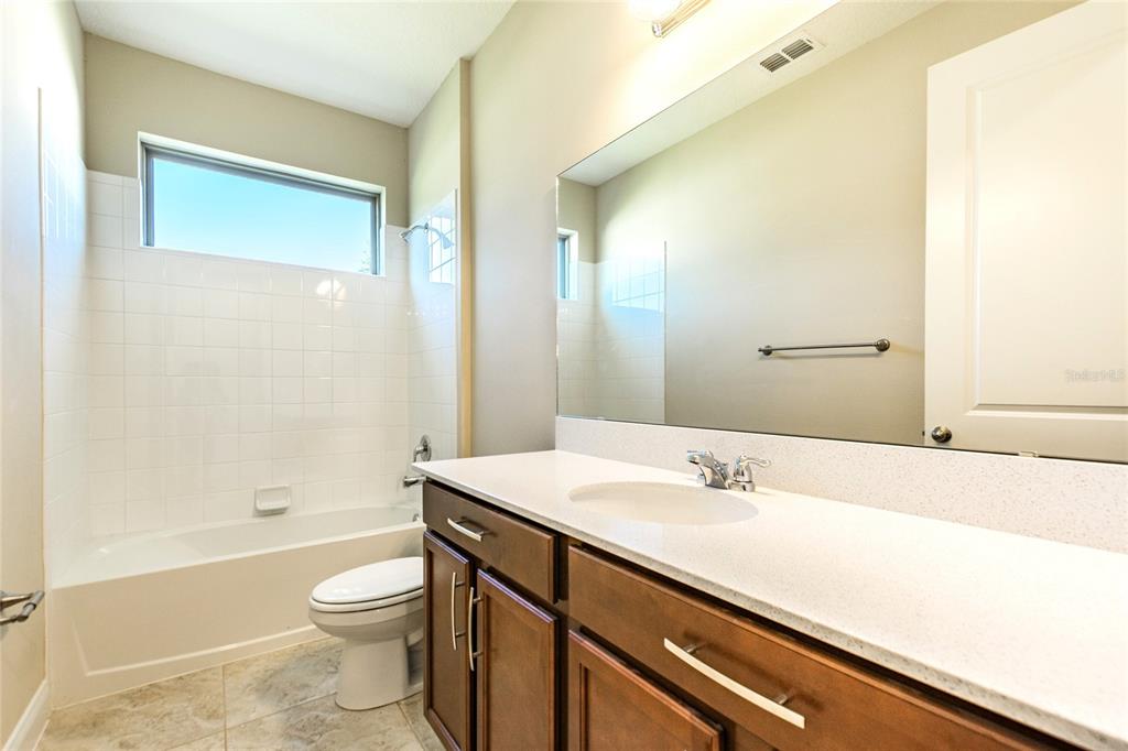 8278 Procida Isle Lane Windermere, FL 34786 - Photo 34 of 90 a bathroom with a sink a toilet and shower