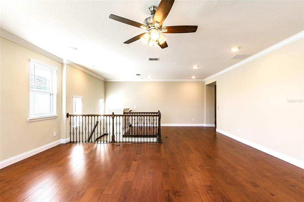 8278 Procida Isle Lane Windermere, FL 34786 - Photo 44 of 90 a view of an empty room with wooden floor