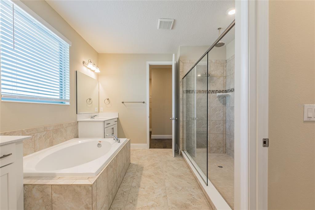 8278 Procida Isle Lane Windermere, FL 34786 - Photo 46 of 90 a bathroom with a tub and shower