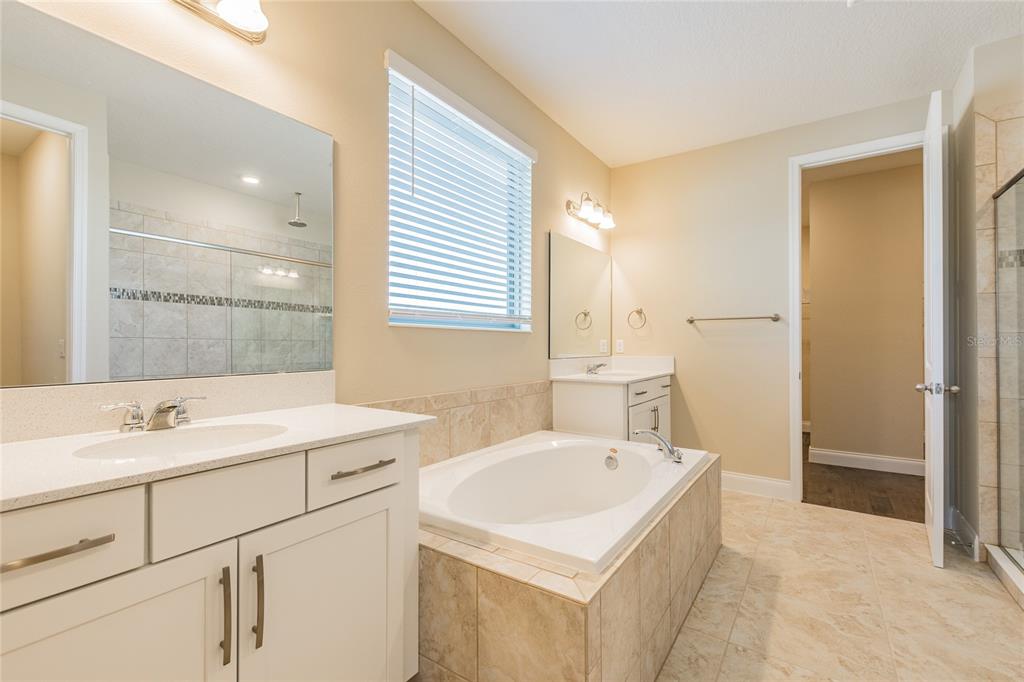 8278 Procida Isle Lane Windermere, FL 34786 - Photo 47 of 90 a bathroom with a sink and a mirror