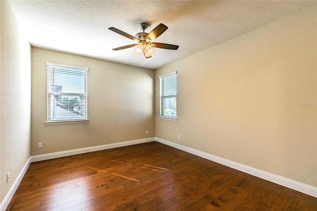 8278 Procida Isle Lane Windermere, FL 34786 - Photo 57 of 90 an empty room with wooden floor and windows