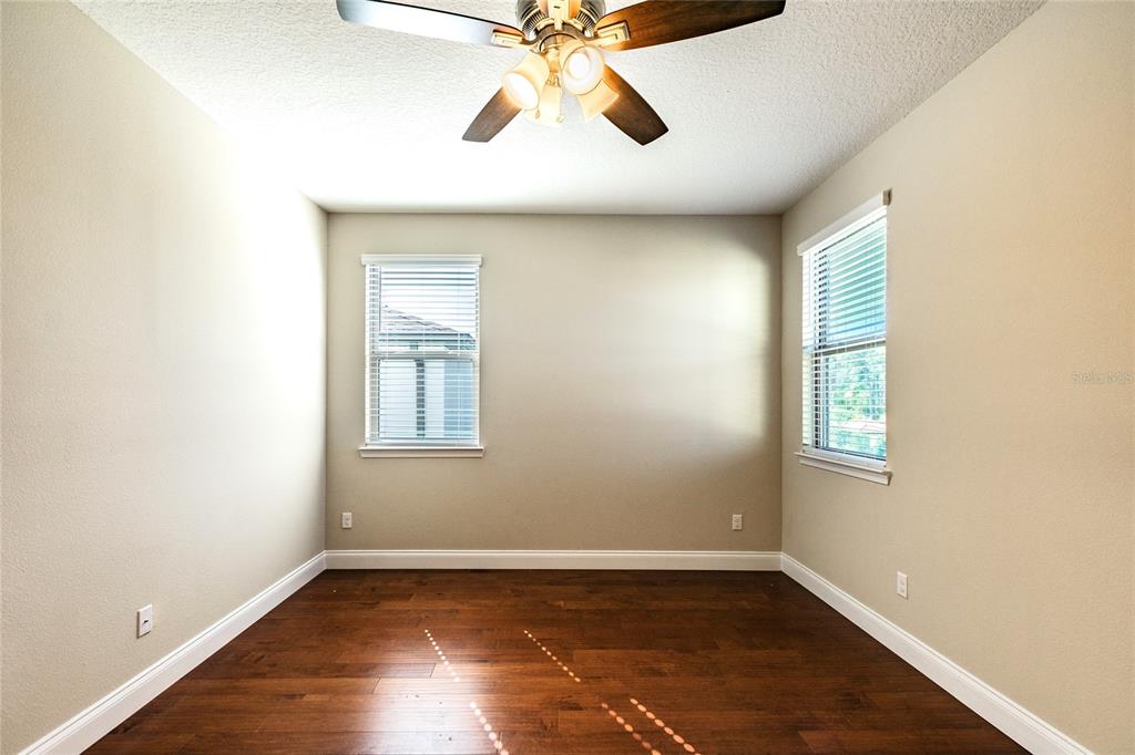 8278 Procida Isle Lane Windermere, FL 34786 - Photo 58 of 90 wooden floor in an empty room with a window