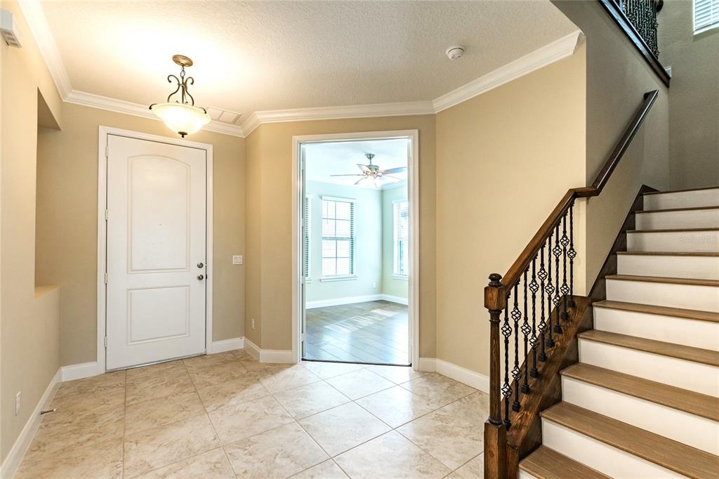 8278 Procida Isle Lane Windermere, FL 34786 - Photo 7 of 90 a view of a hallway with wooden floor and staircase