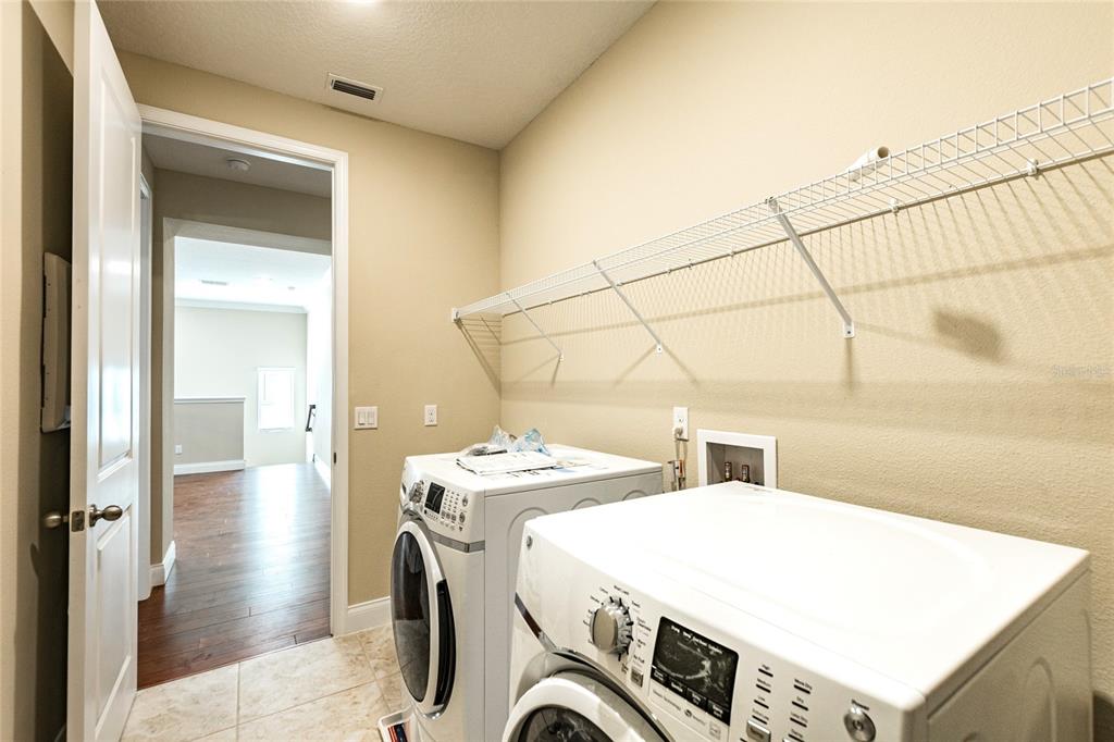 8278 Procida Isle Lane Windermere, FL 34786 - Photo 75 of 90 a utility room with dryer and washer