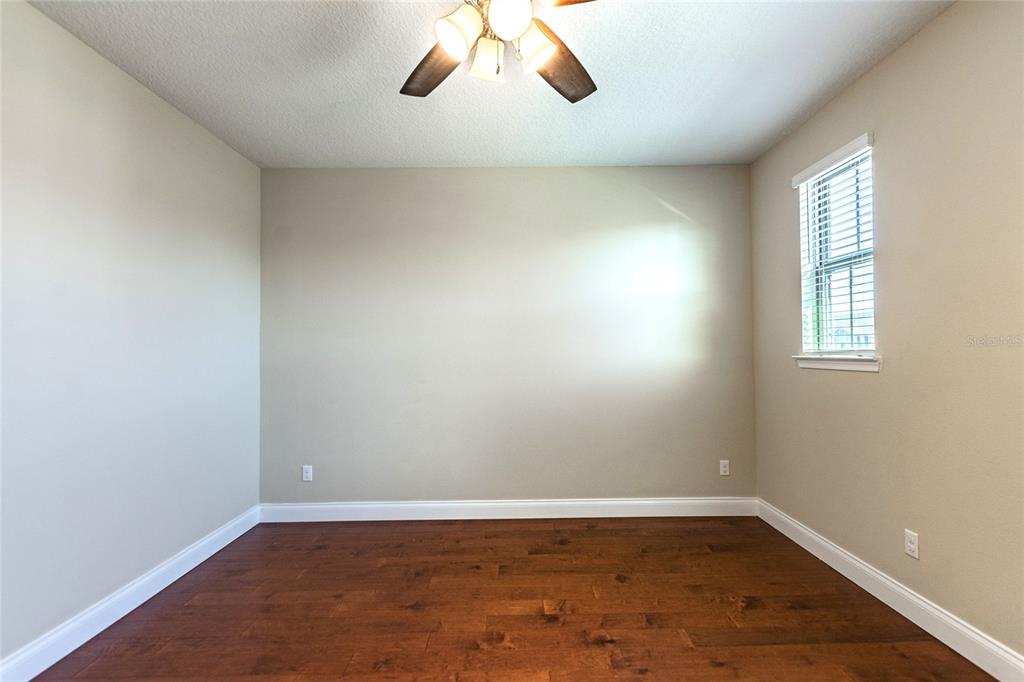 8278 Procida Isle Lane Windermere, FL 34786 - Photo 77 of 90 an empty room with wooden floor and windows