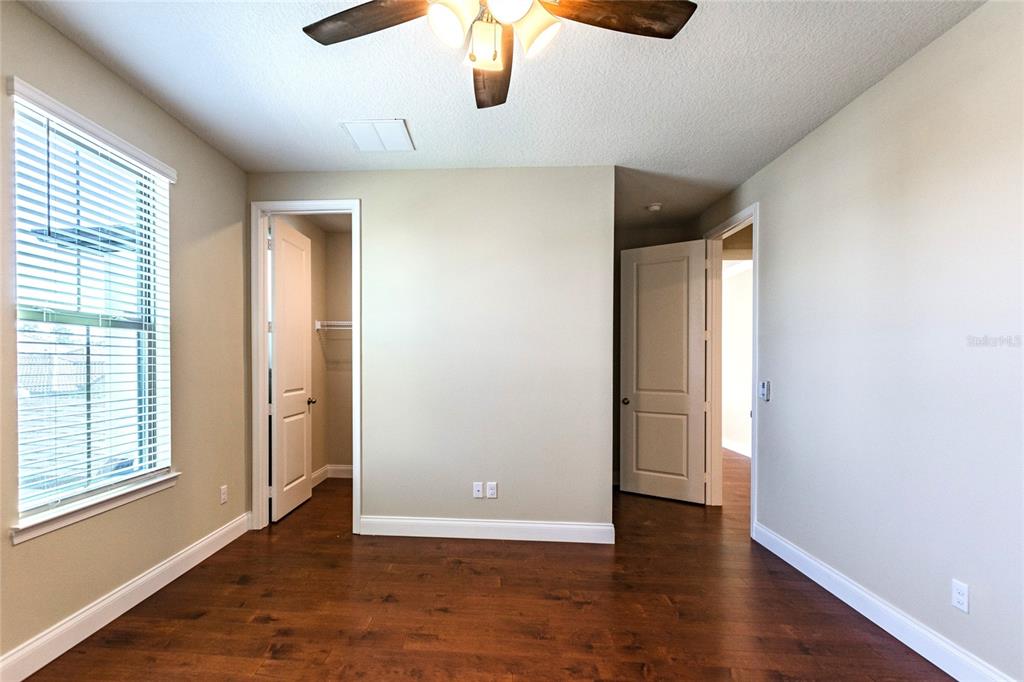 8278 Procida Isle Lane Windermere, FL 34786 - Photo 78 of 90 an empty room with wooden floor and windows