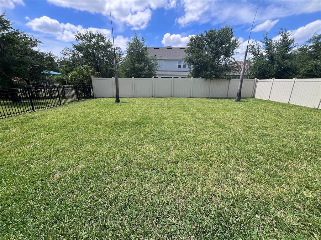 8278 Procida Isle Lane Windermere, FL 34786 - Photo 87 of 90 a view of a backyard with a trampoline