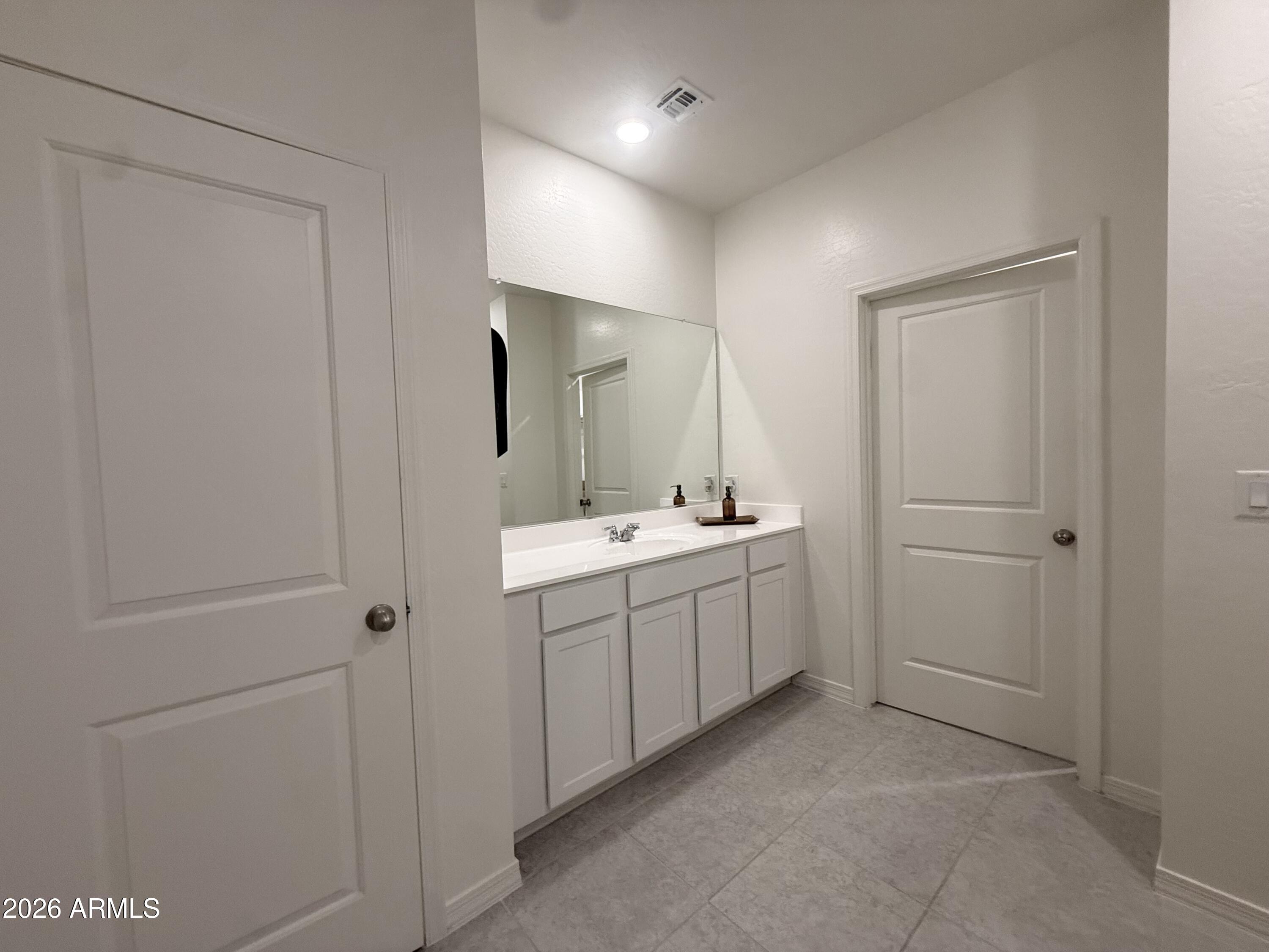 25839 North Boreas Road Florence, AZ 85132 - Photo 12 of 20 a bathroom with a sink and mirror