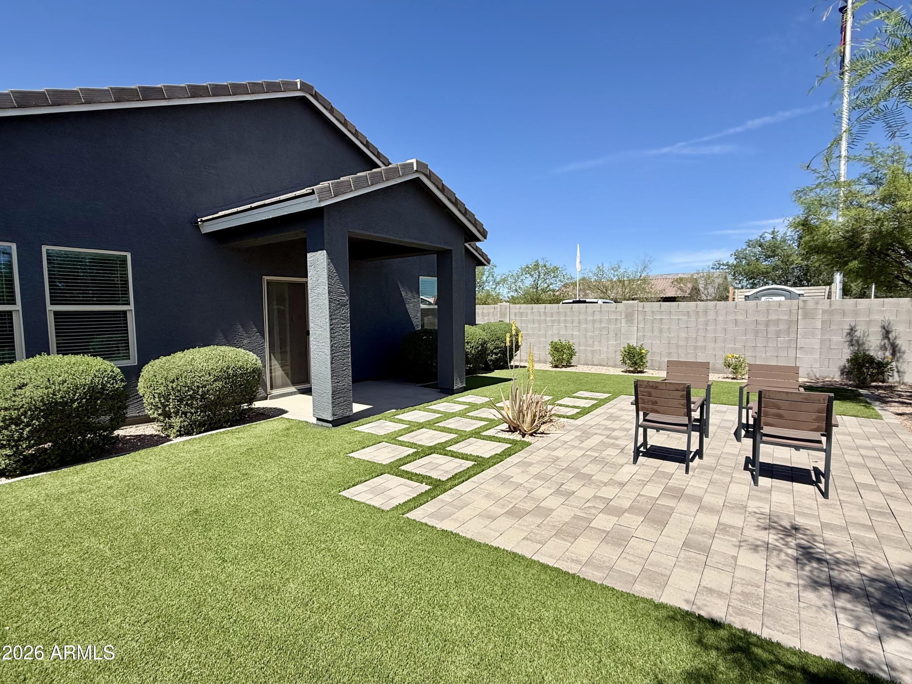 25839 North Boreas Road Florence, AZ 85132 - Photo 15 of 20 a view of a patio with table and chairs near a yard