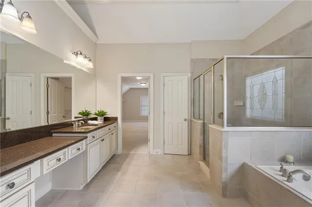 a large white kitchen with a sink and refrigerator