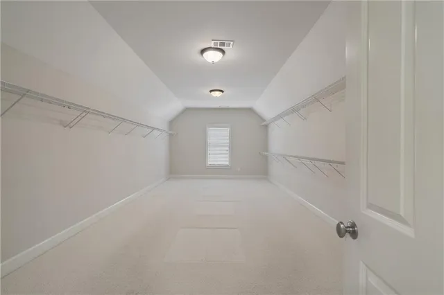 a view of a big room with closet and windows