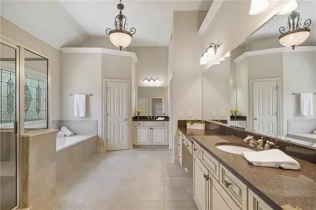 a large bathroom with a granite countertop sink a large mirror and shower