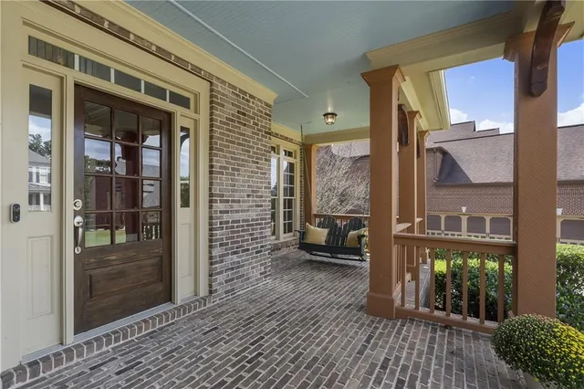 a view of a balcony with chairs and a barbeque