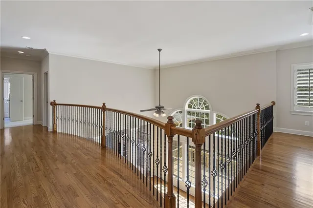 a view of a hallway with wooden floor