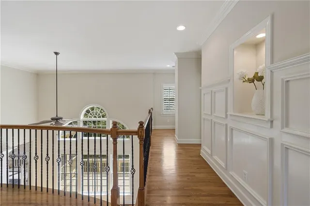 a view of a hallway with wooden floor