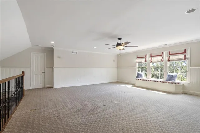 a view of a livingroom with a ceiling fan and window