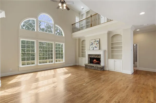 a view of an empty room with a fireplace and a window