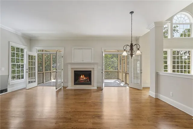 a view of empty room with wooden floor and fireplace