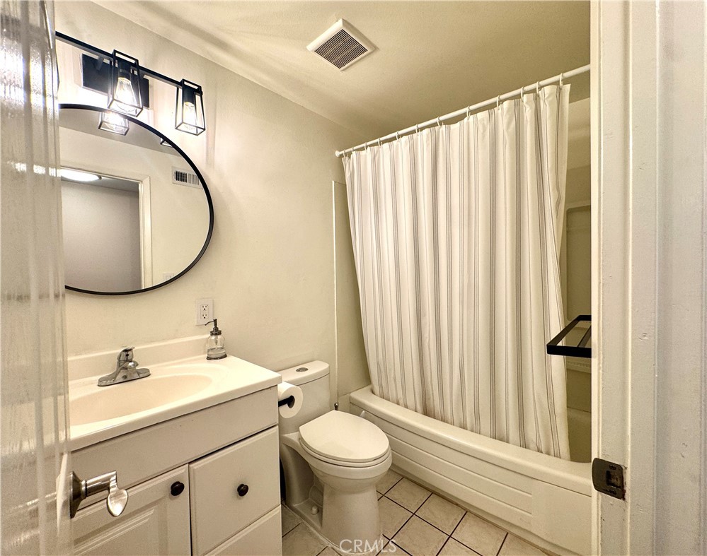 2065 Morley Street Simi Valley, CA 93065 - Photo 9 of 13 a bathroom with a toilet a sink and a mirror