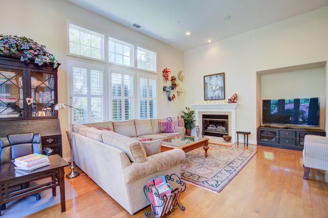 a living room with fireplace furniture and a flat screen tv