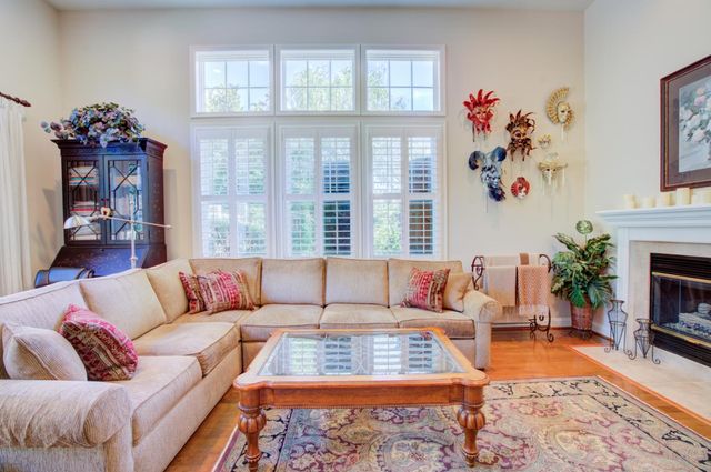 a living room with furniture fireplace and window