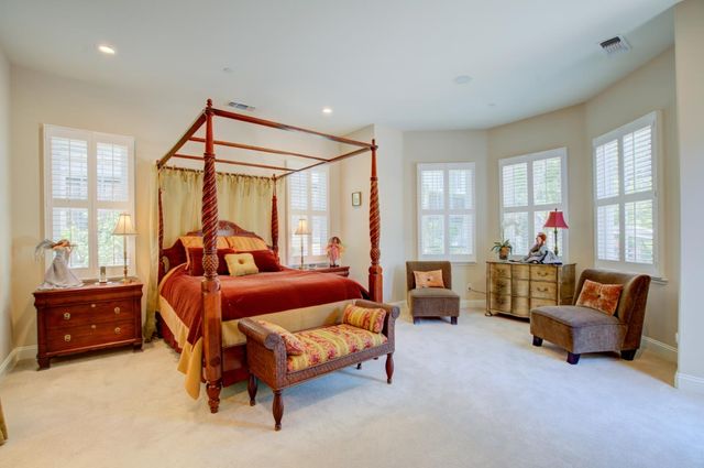 a bedroom with furniture and a window