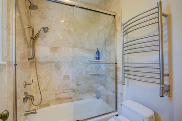 a bathroom with a shower and a toilet